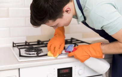Kitchen Deep Cleaning Man cleaning cooker